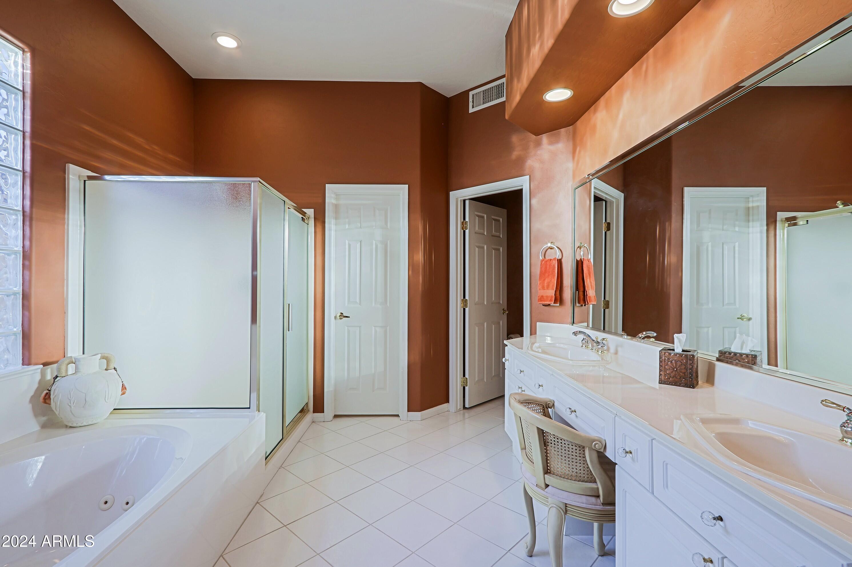 6135 East Evening Glow Drive Scottsdale, AZ 85266 - Photo 37 of 118 a bathroom with a double vanity sink and a mirror