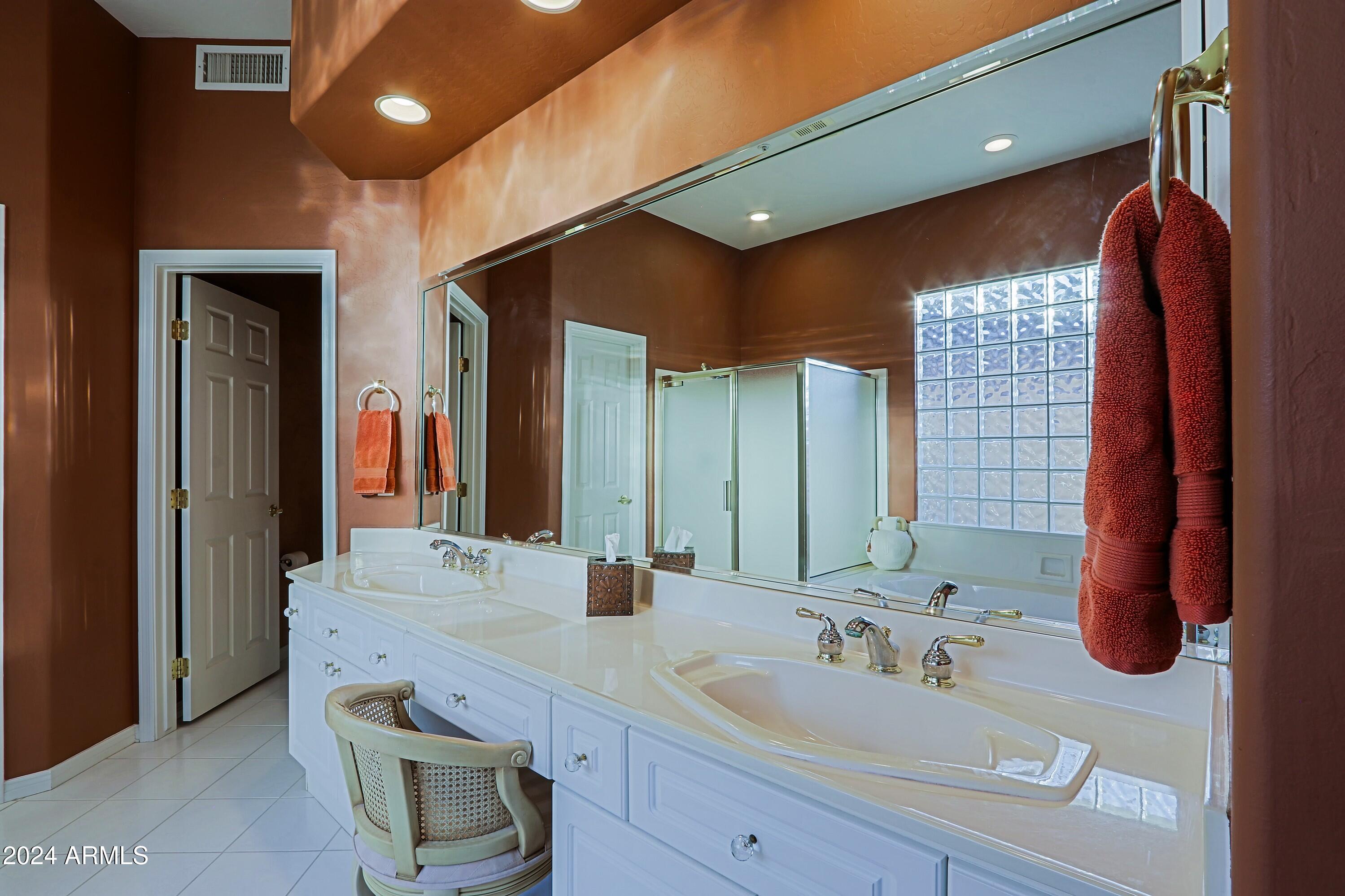 6135 East Evening Glow Drive Scottsdale, AZ 85266 - Photo 38 of 118 a bathroom with a double vanity sink a mirror and a shower
