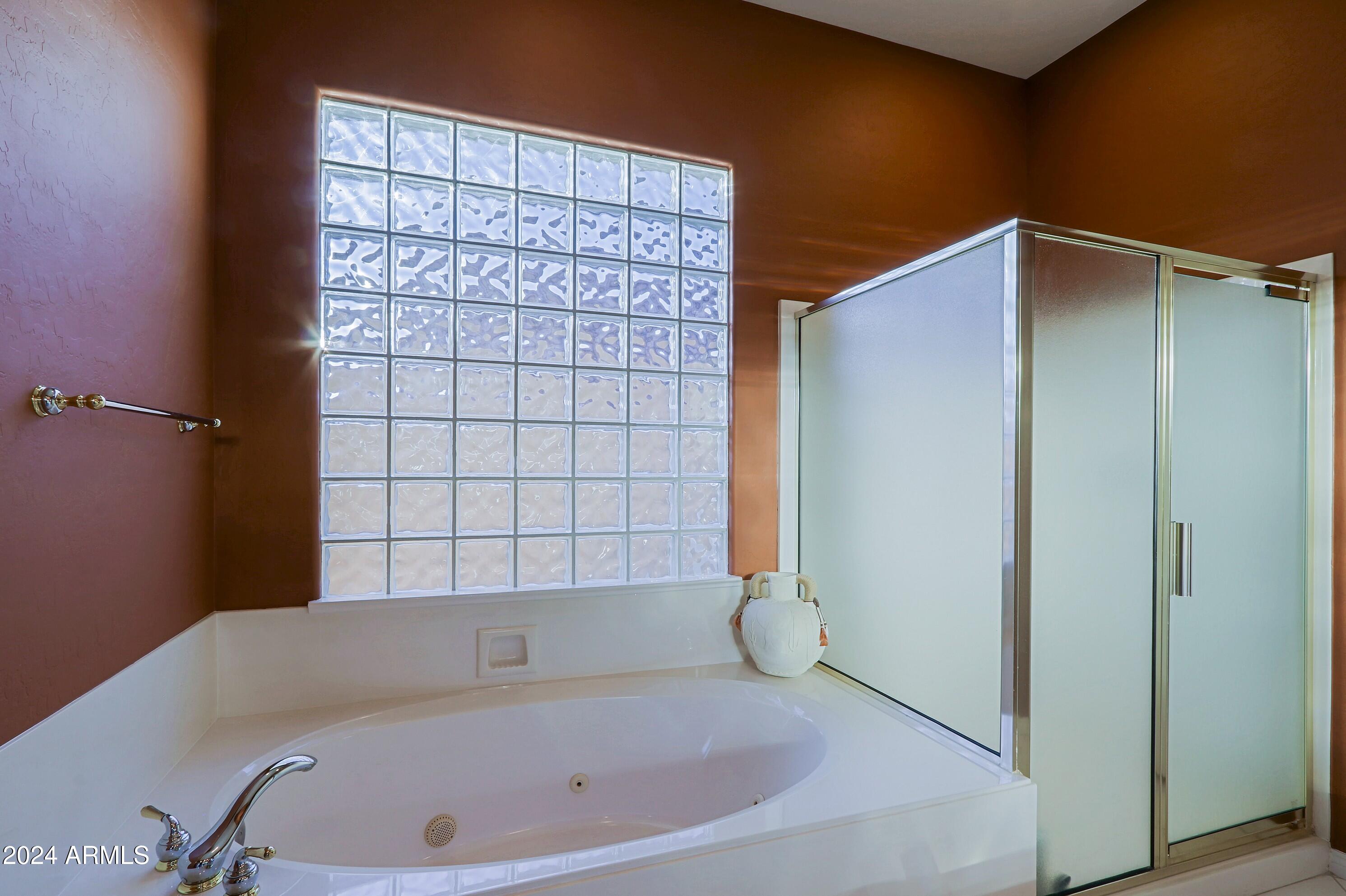 6135 East Evening Glow Drive Scottsdale, AZ 85266 - Photo 39 of 118 a bathroom with a bathtub and shower