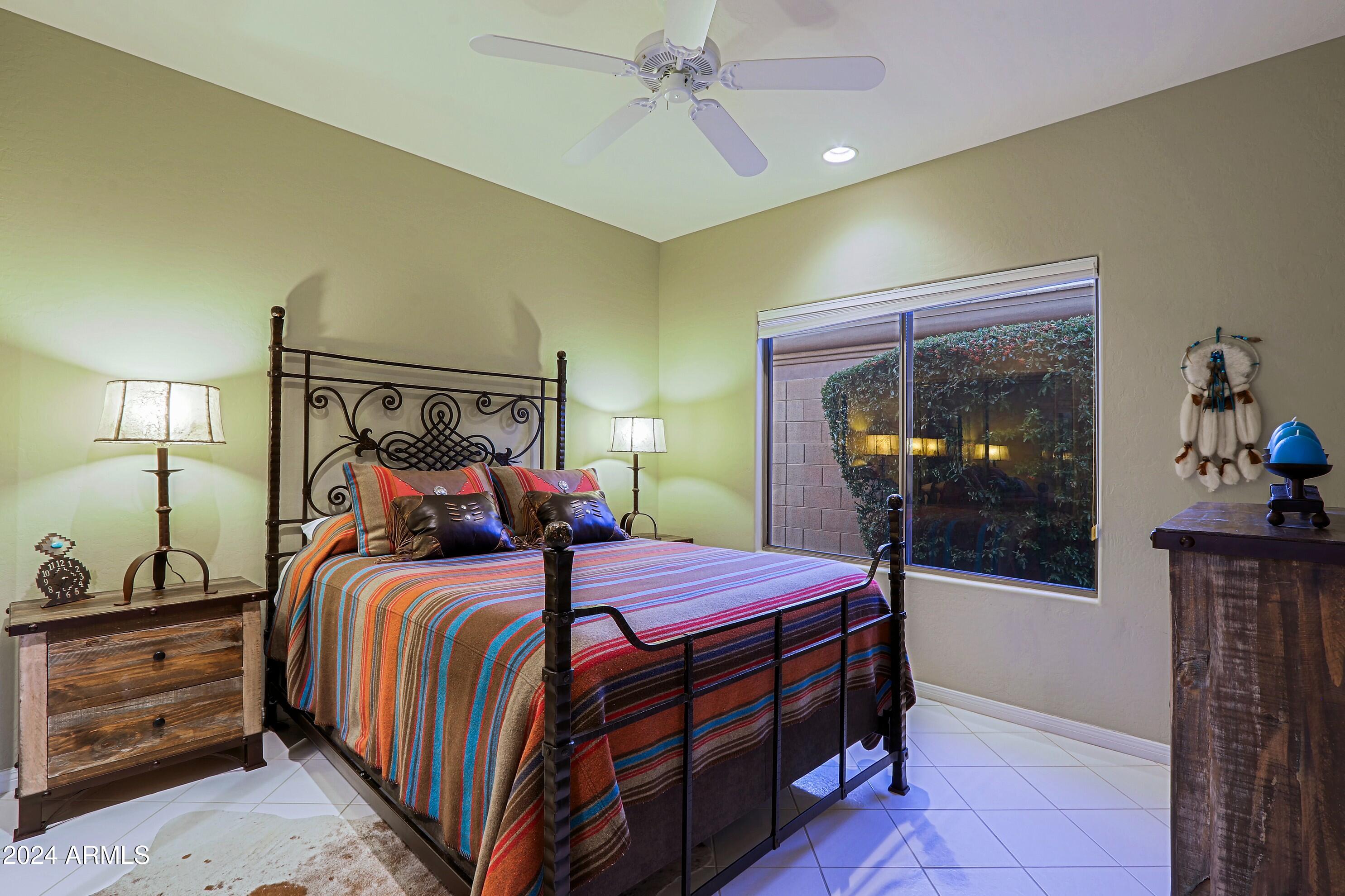 6135 East Evening Glow Drive Scottsdale, AZ 85266 - Photo 43 of 118 a bedroom with a bed and a mirror