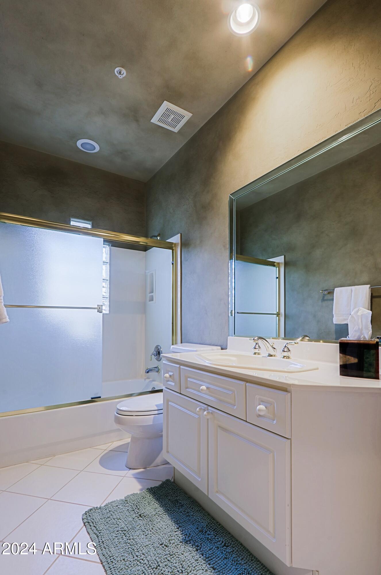 6135 East Evening Glow Drive Scottsdale, AZ 85266 - Photo 47 of 118 a bathroom with a sink a toilet and mirror