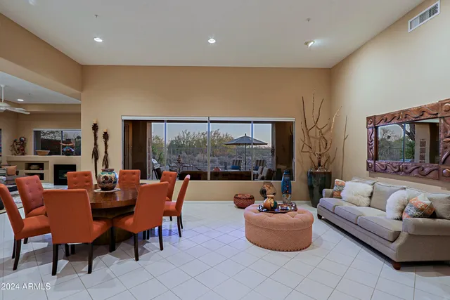 a living room with furniture and large windows