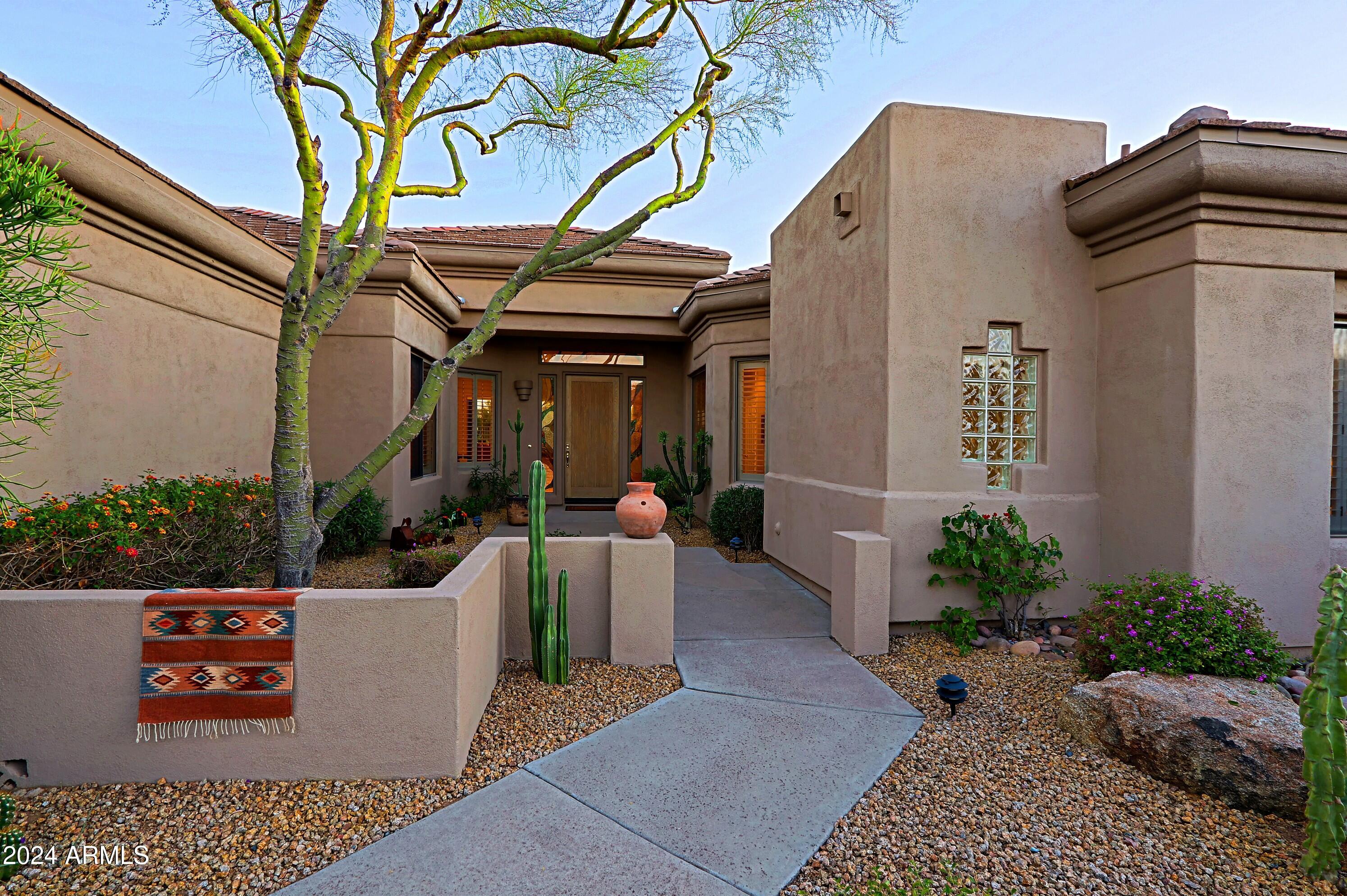 6135 East Evening Glow Drive Scottsdale, AZ 85266 - Photo 56 of 118 a view of a patio with couches table and chairs and potted plants