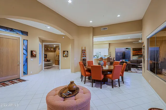 a living room with furniture and a mirror
