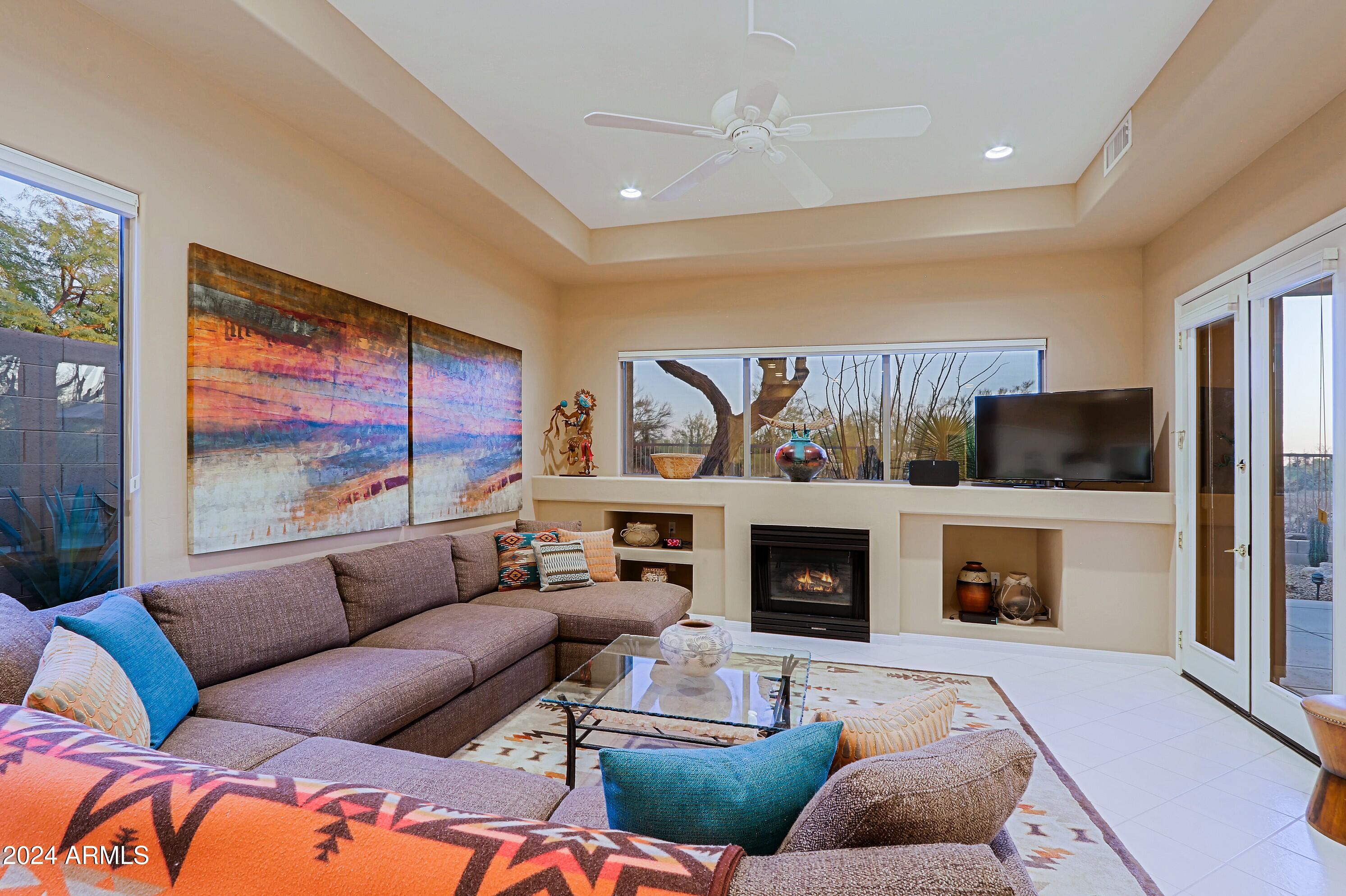 6135 East Evening Glow Drive Scottsdale, AZ 85266 - Photo 8 of 118 a living room with furniture fireplace and flat screen tv