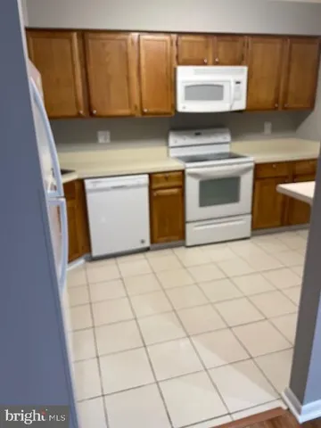 a kitchen with granite countertop a stove a sink and a microwave