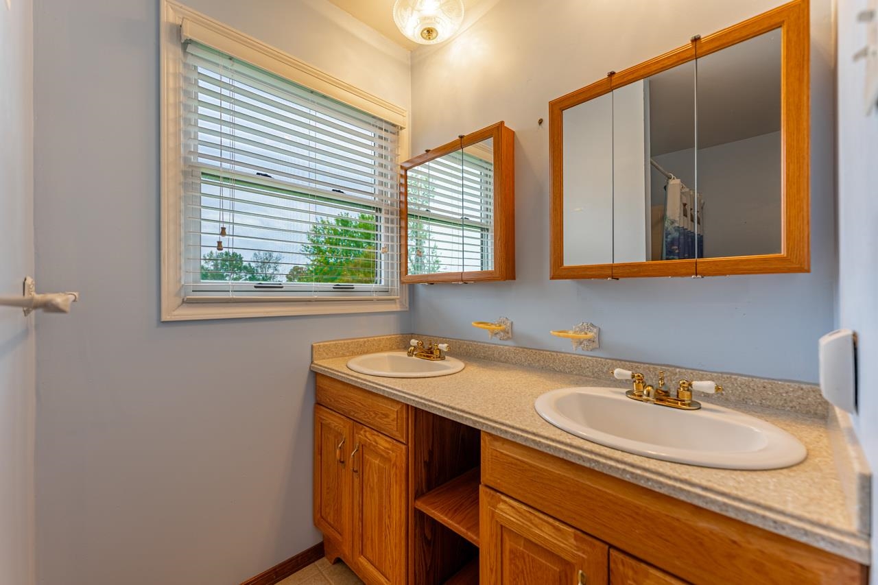 17219 Green Road Harvard, IL 60033 - Photo 26 of 44 a bathroom with a sink and a mirror