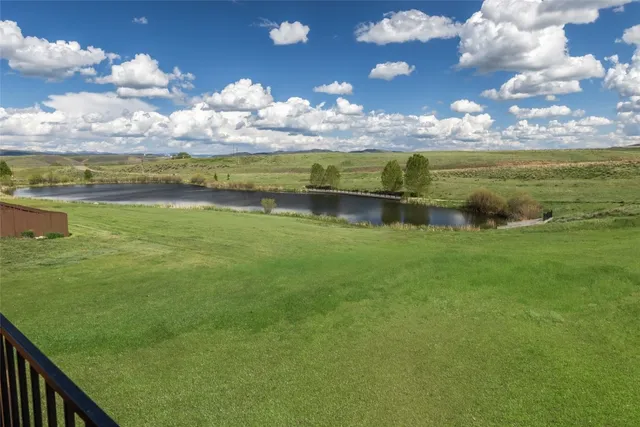 a view of a lake with houses in the background