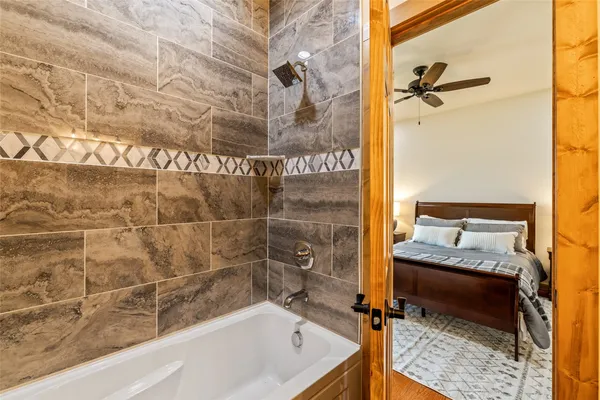 a bathroom with a tub and a shower