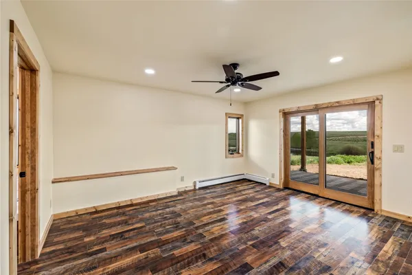 a view of an empty room with glass door