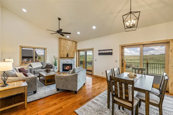 a living room with fireplace furniture and a chandelier