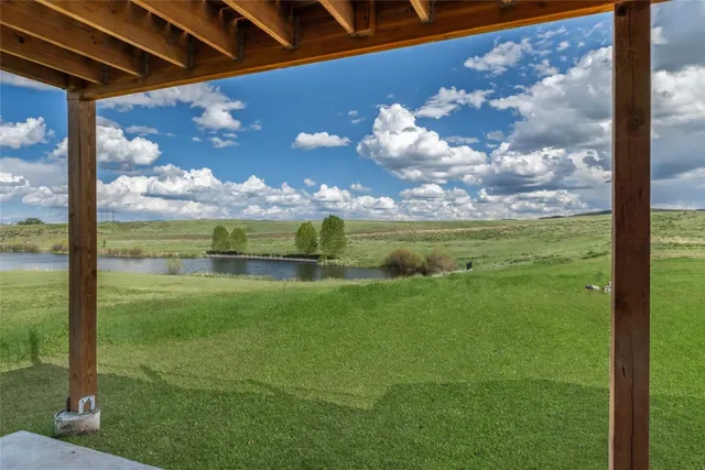 a view of a back yard of a house with a big yard