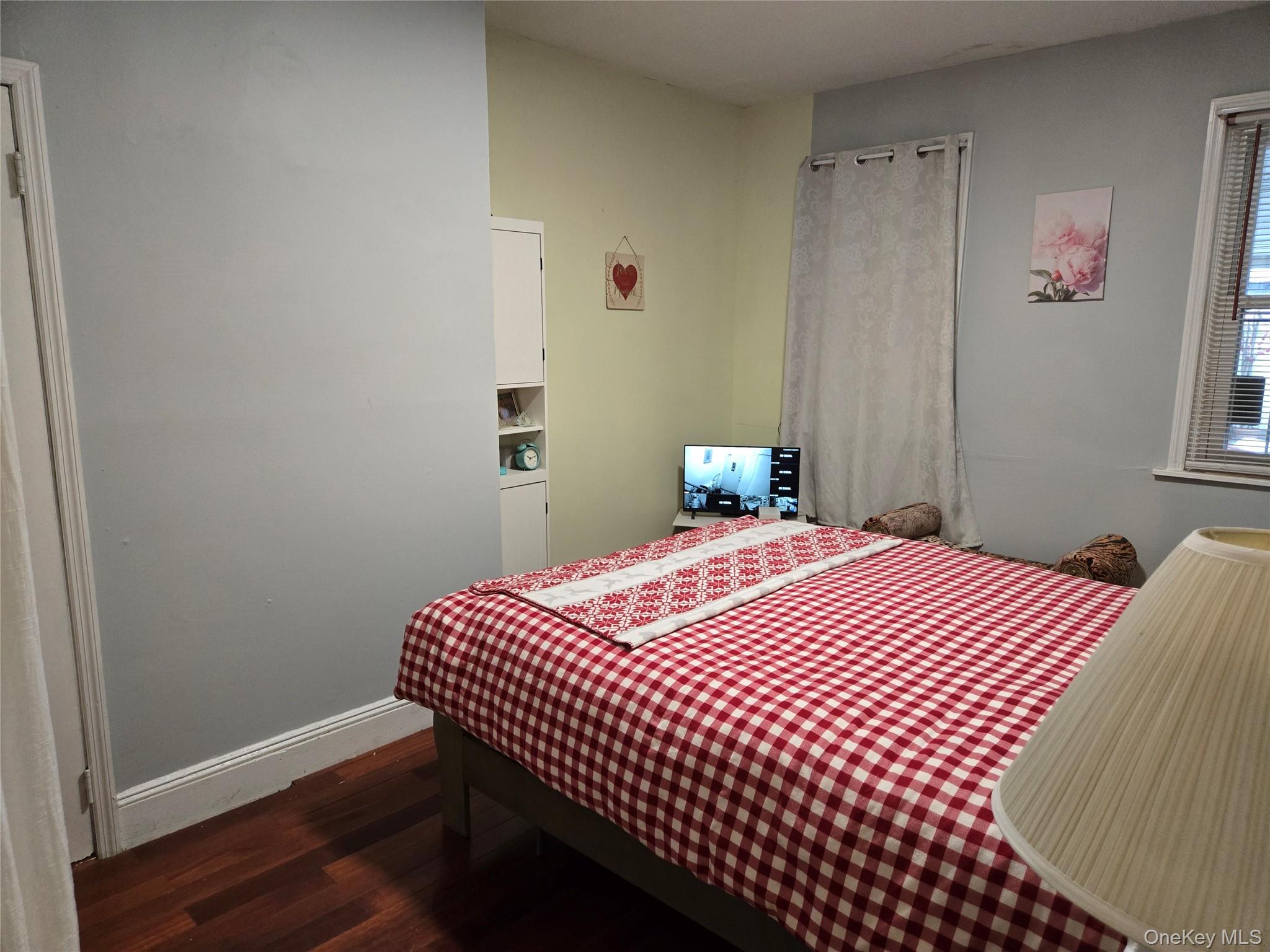 88-30 75th Street Queens, NY 11421 - Photo 11 of 23 a bedroom with a bed and wooden floor