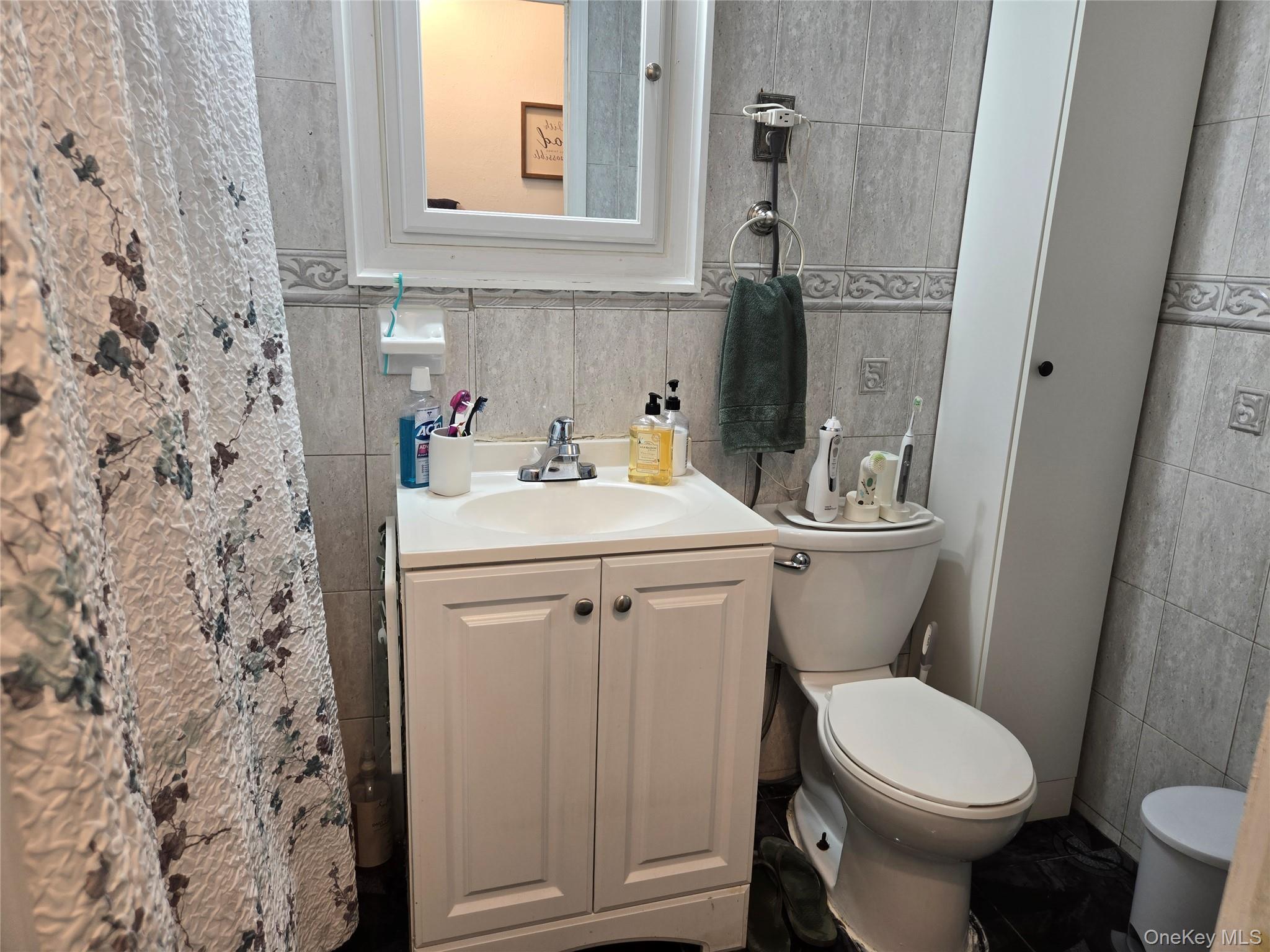 88-30 75th Street Queens, NY 11421 - Photo 12 of 23 a bathroom with a sink toilet and mirror