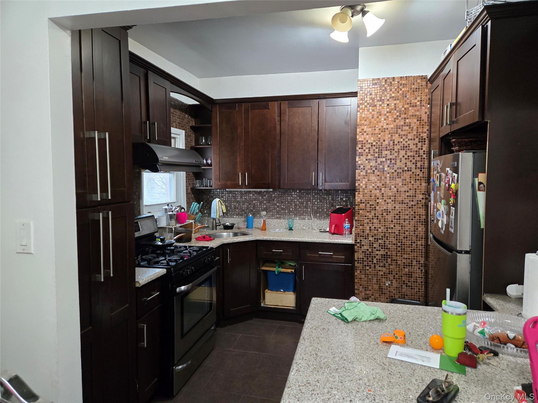88-30 75th Street Queens, NY 11421 - Photo 15 of 23 a kitchen with a sink stove and cabinets