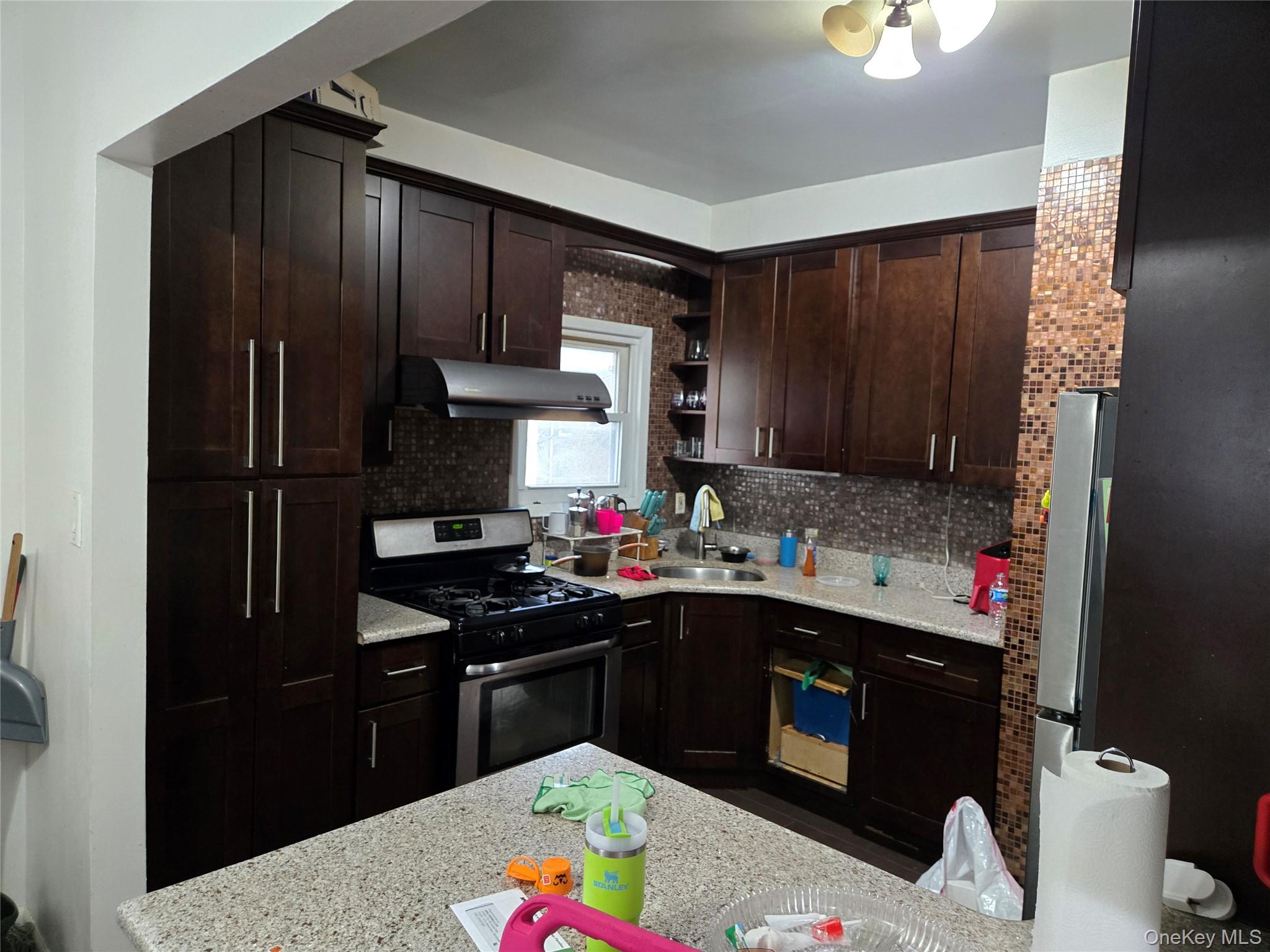 88-30 75th Street Queens, NY 11421 - Photo 16 of 23 a kitchen with a sink stove and refrigerator