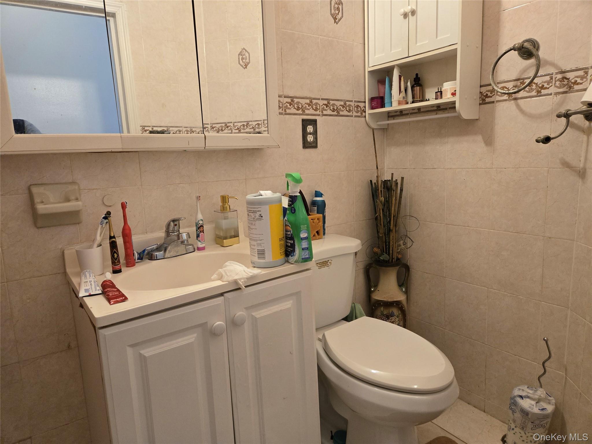 88-30 75th Street Queens, NY 11421 - Photo 20 of 23 a bathroom with a sink a toilet and vanity