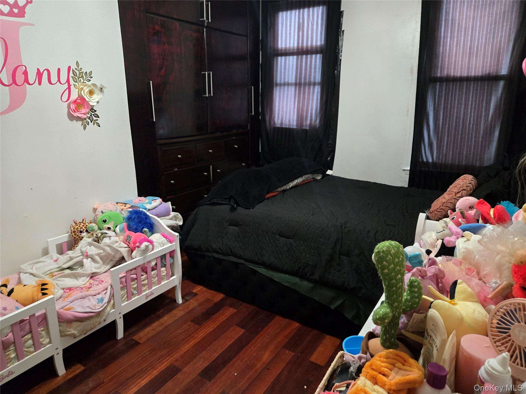 88-30 75th Street Queens, NY 11421 - Photo 21 of 23 a bedroom with a bed window and dresser