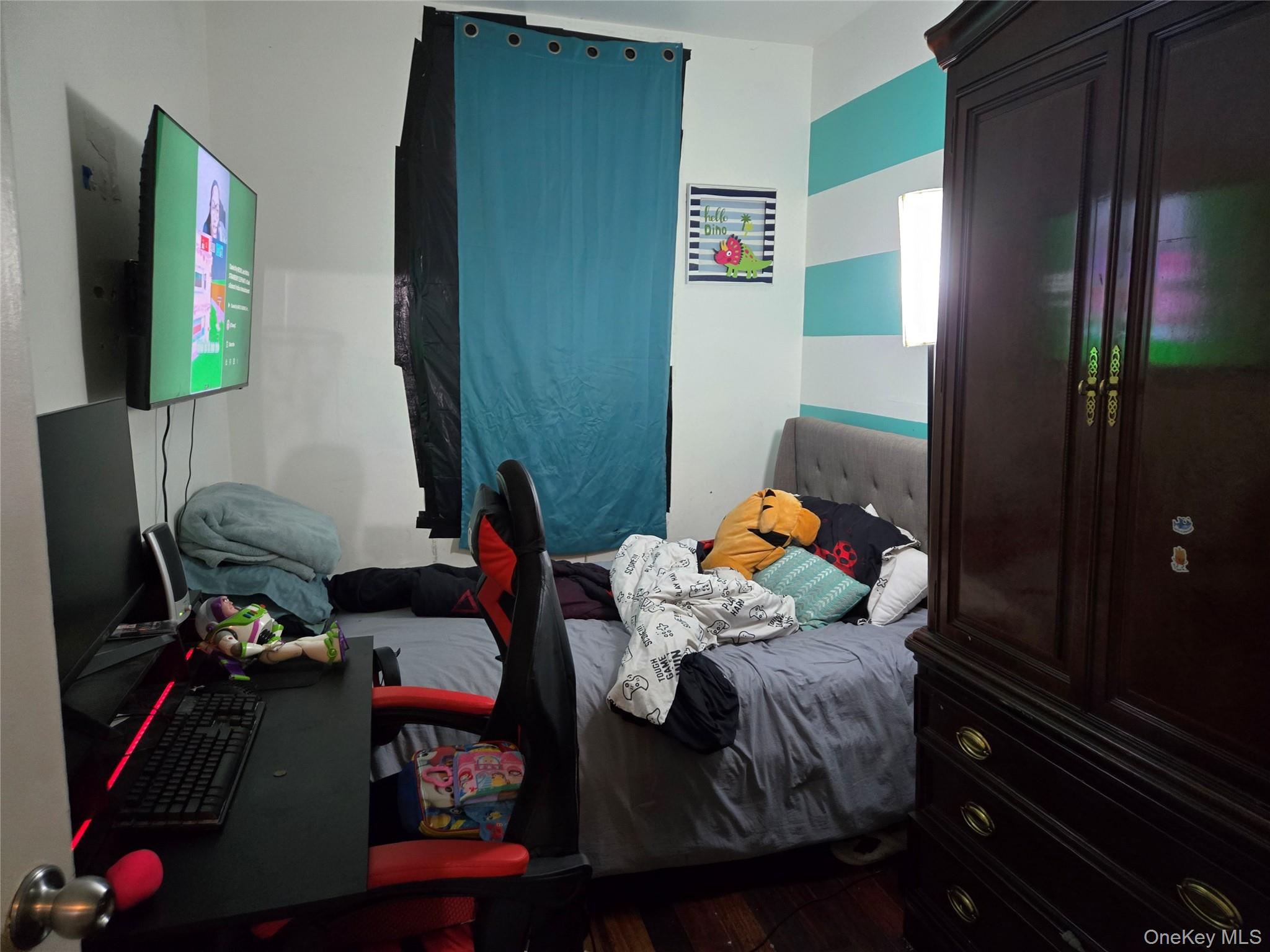 88-30 75th Street Queens, NY 11421 - Photo 23 of 23 a bedroom with a bed and a window