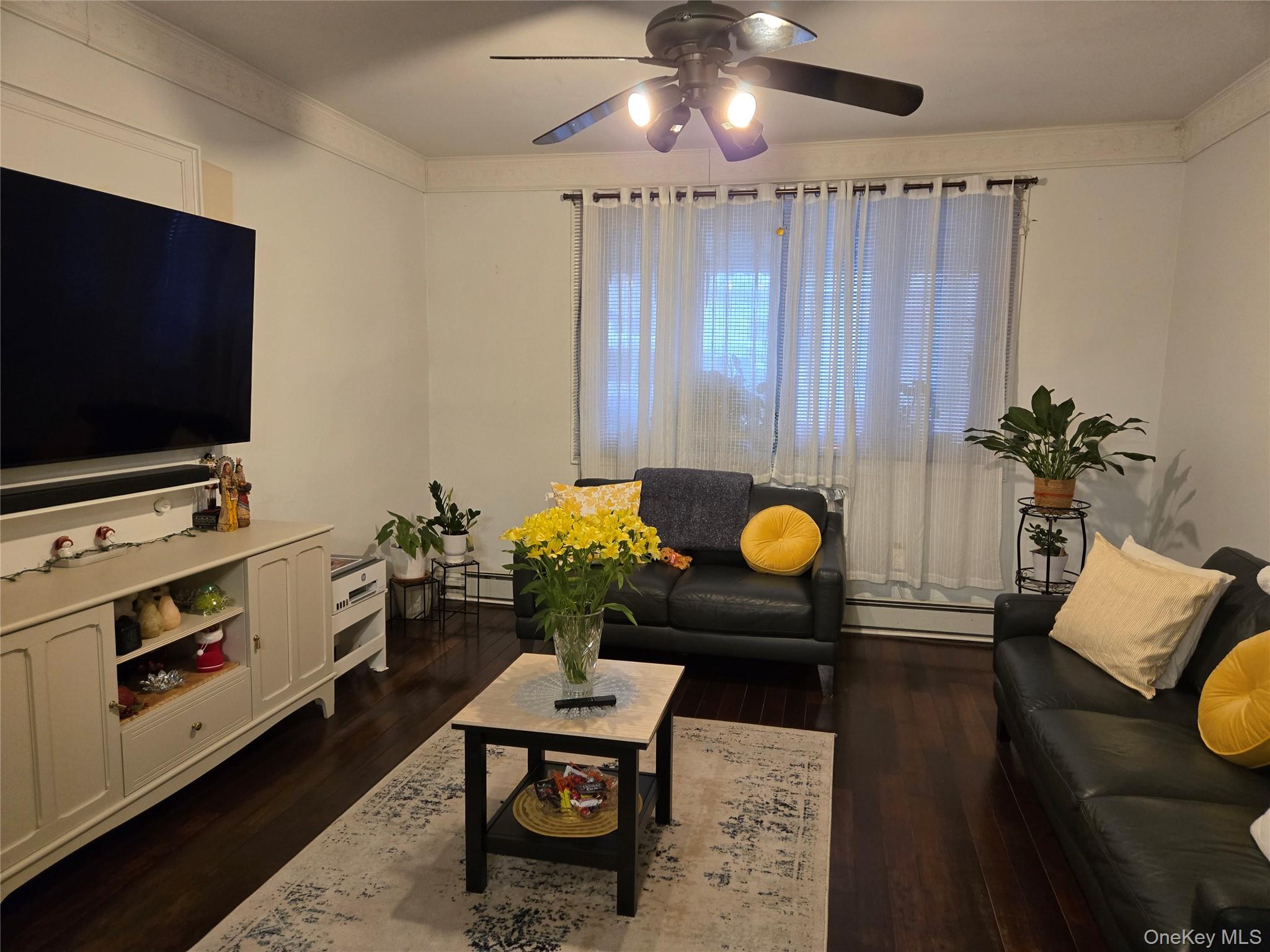 88-30 75th Street Queens, NY 11421 - Photo 7 of 23 a living room with furniture and a flat screen tv