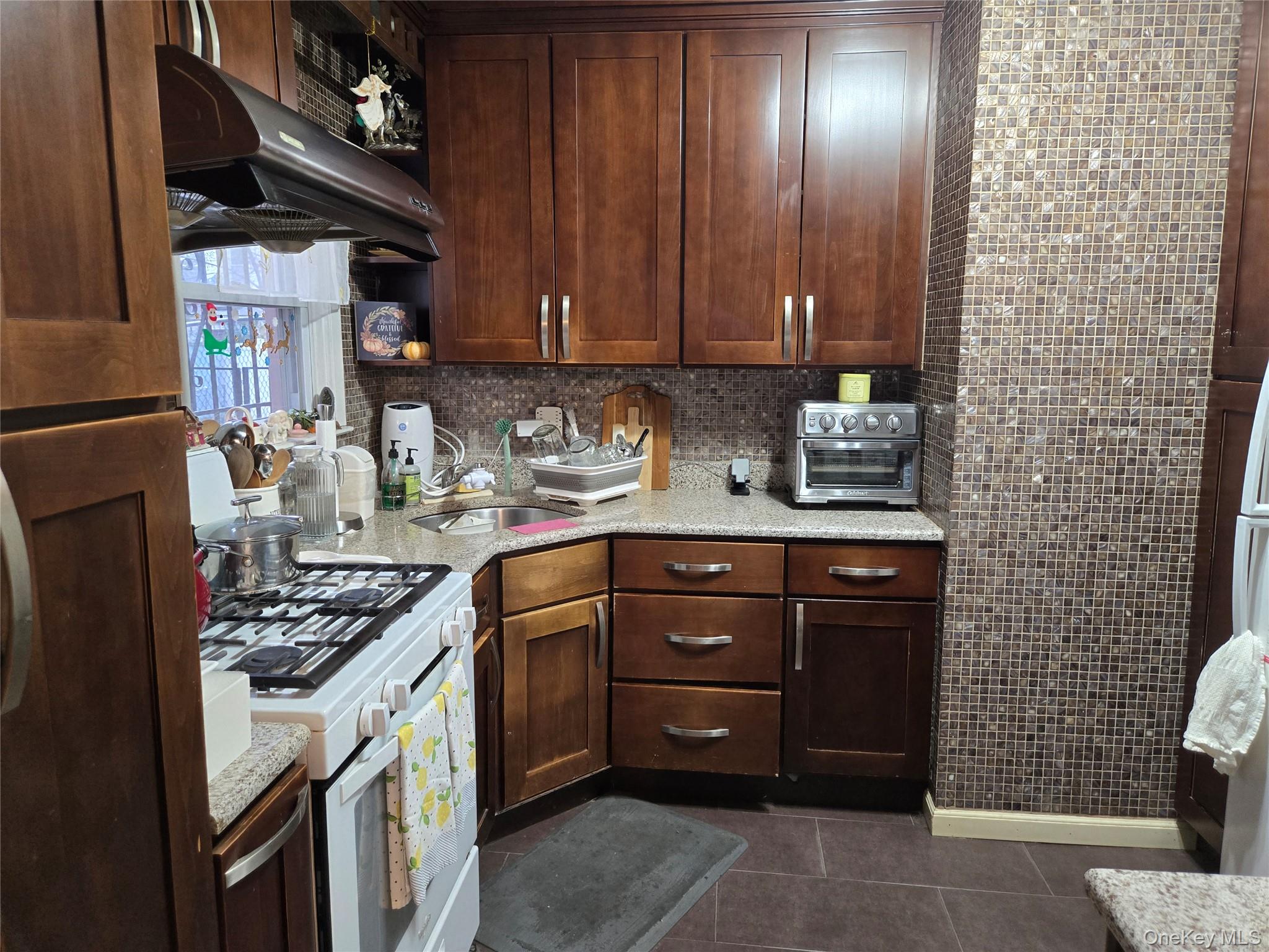 88-30 75th Street Queens, NY 11421 - Photo 8 of 23 a kitchen with a cabinets and stove