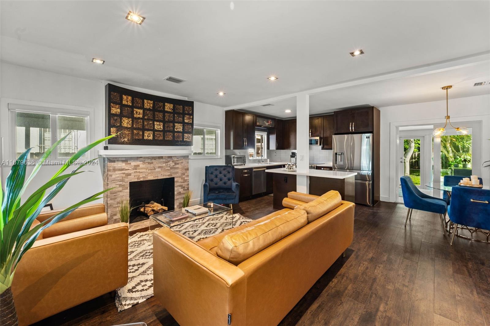 1757 Southwest 24th Terrace Miami, FL 33145 - Photo 1 of 26 a living room with stainless steel appliances furniture a fireplace and a open kitchen view