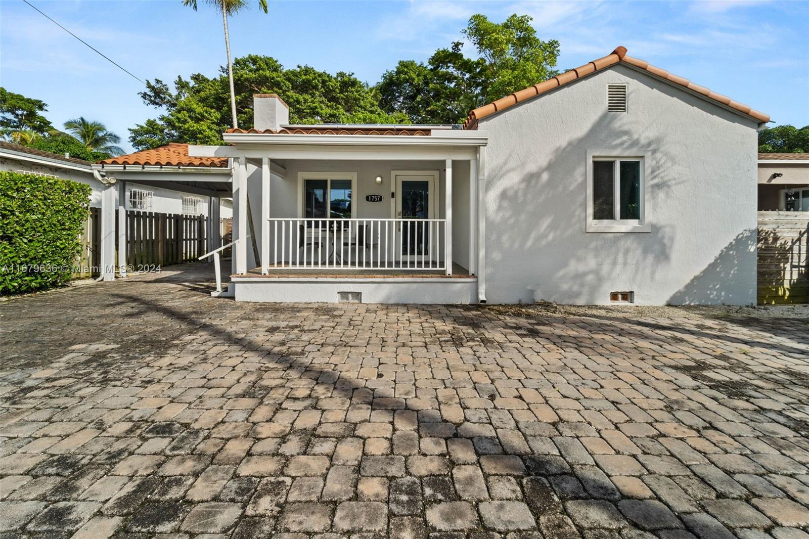 1757 Southwest 24th Terrace Miami, FL 33145 - Photo 16 of 26 a front view of a house with a yard