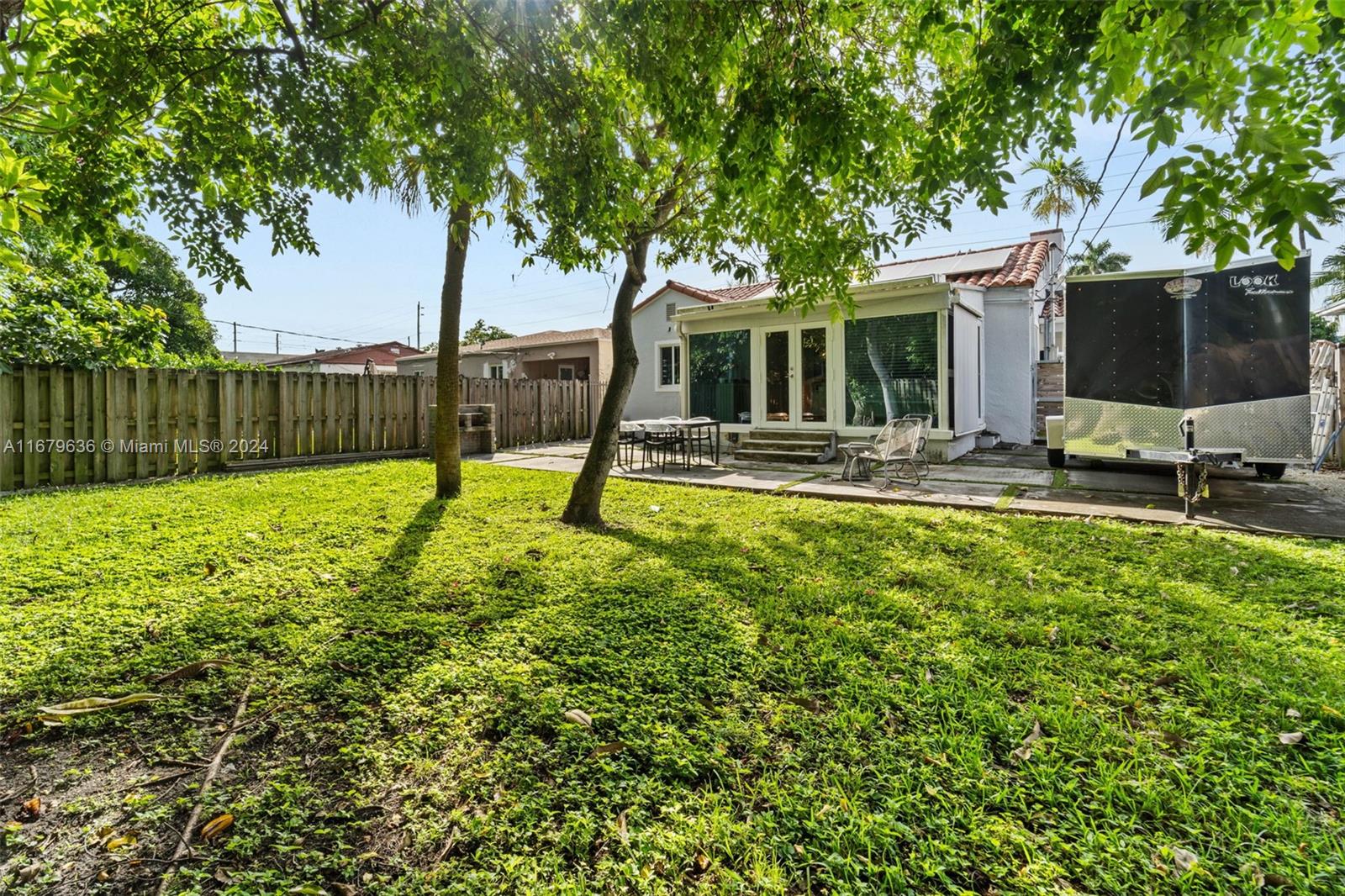 1757 Southwest 24th Terrace Miami, FL 33145 - Photo 18 of 26 a view of a backyard with a table and chairs