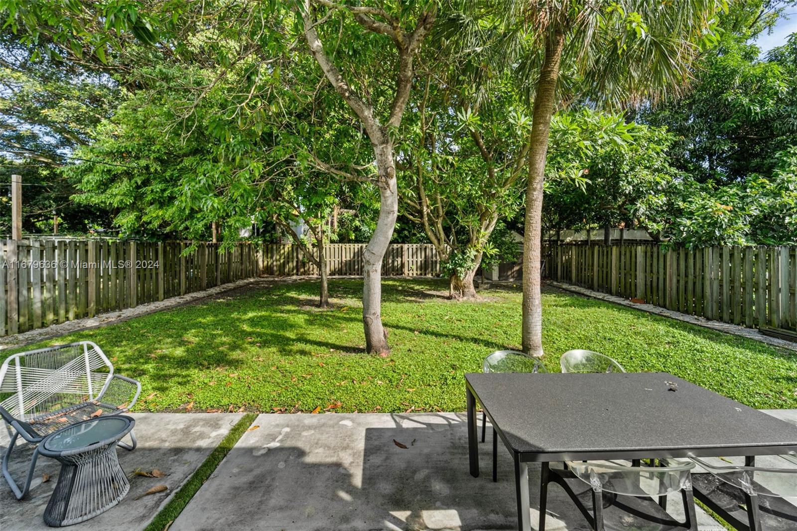 1757 Southwest 24th Terrace Miami, FL 33145 - Photo 19 of 26 a view of a wooden deck with chairs and a yard