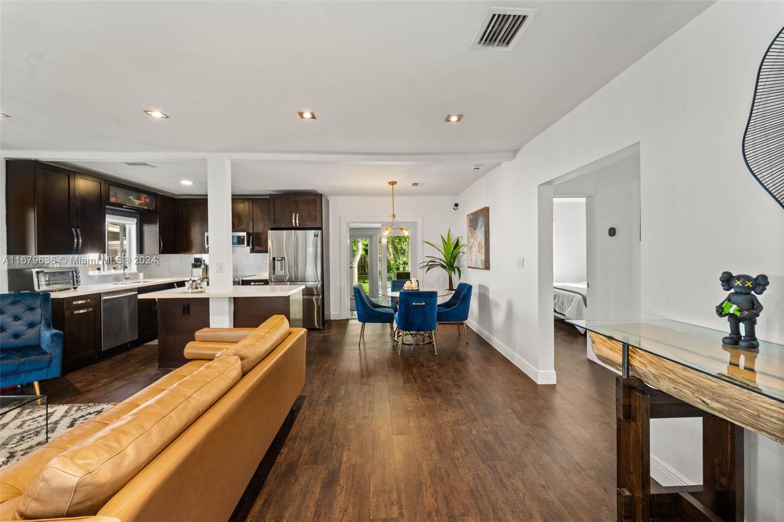 1757 Southwest 24th Terrace Miami, FL 33145 - Photo 5 of 26 a living room with stainless steel appliances kitchen island granite countertop furniture wooden floor and a view of kitchen