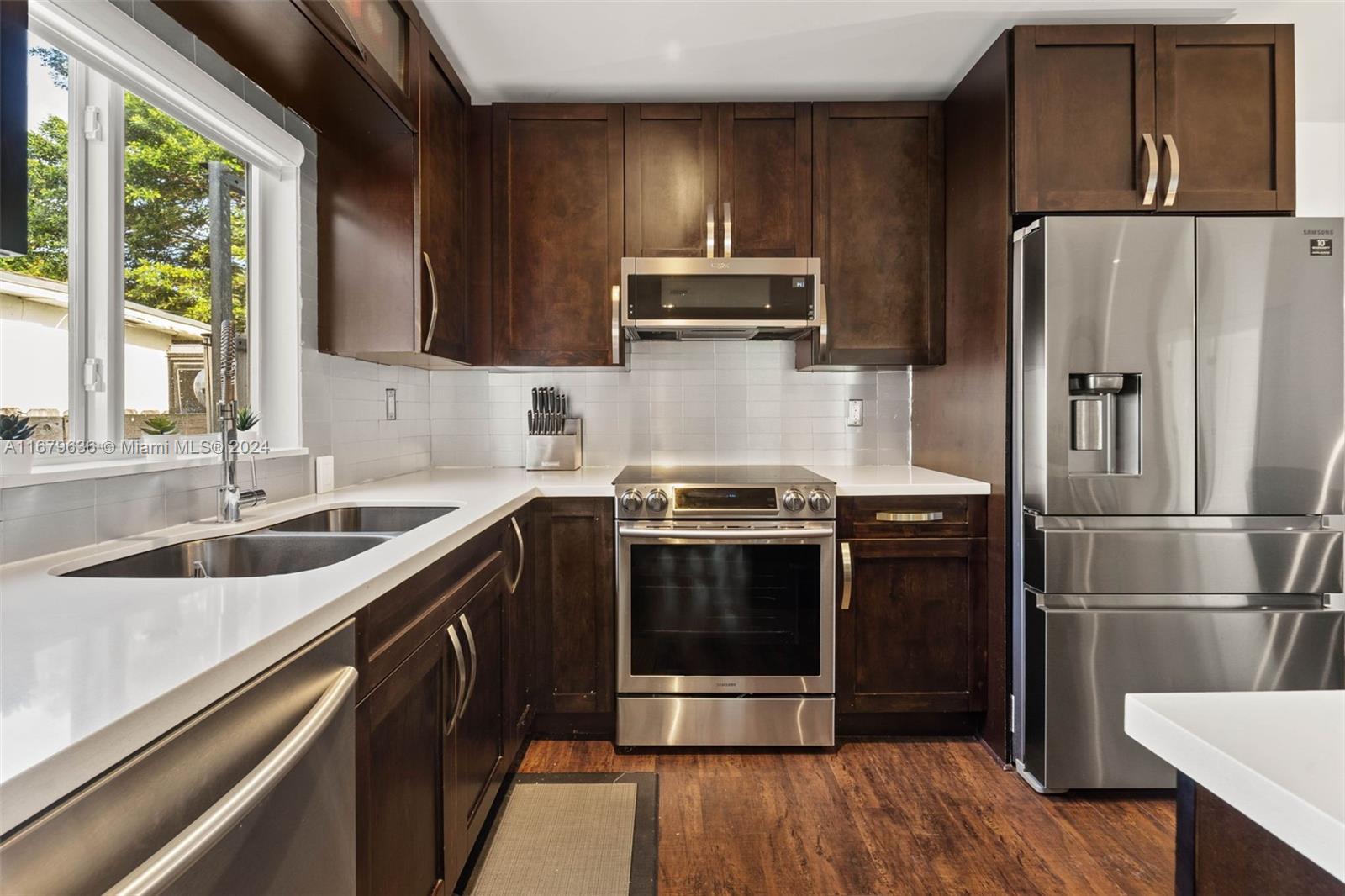 1757 Southwest 24th Terrace Miami, FL 33145 - Photo 6 of 26 a kitchen with a sink stove and refrigerator