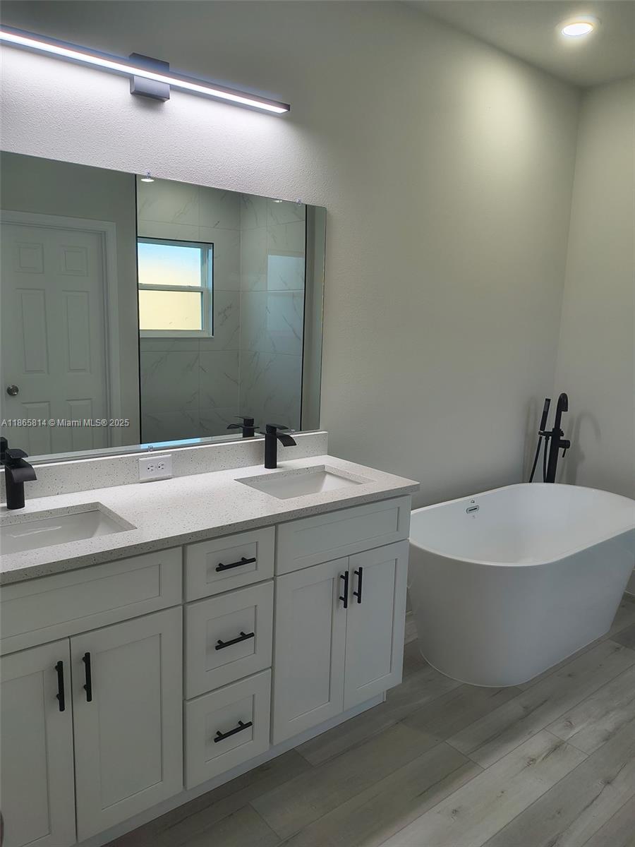 16745 Southwest 29th Terrace Ocala, FL 34473 - Photo 7 of 21 a bathroom with a double vanity sink and a mirror