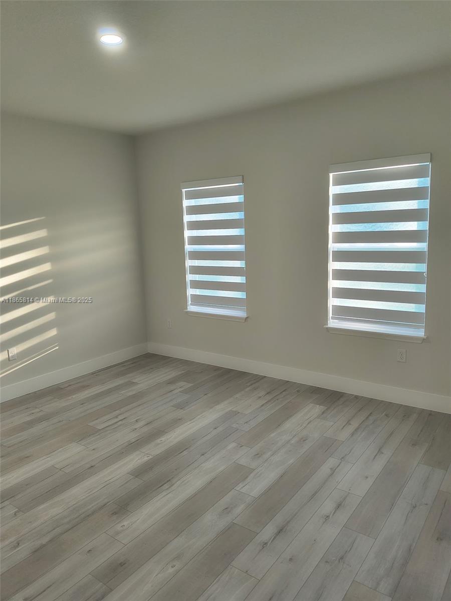 16745 Southwest 29th Terrace Ocala, FL 34473 - Photo 10 of 21 a view of an empty room with wooden floor and a window