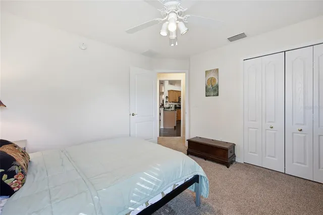 a bedroom with bed and a chandelier
