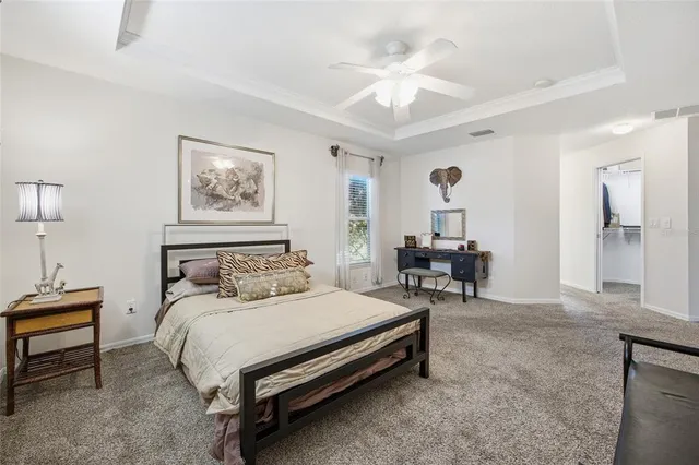 a bed room with a bed and a chandelier