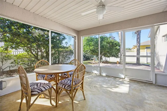 a dining room with furniture and a large window