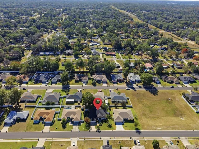 an aerial view of residential houses with outdoor space