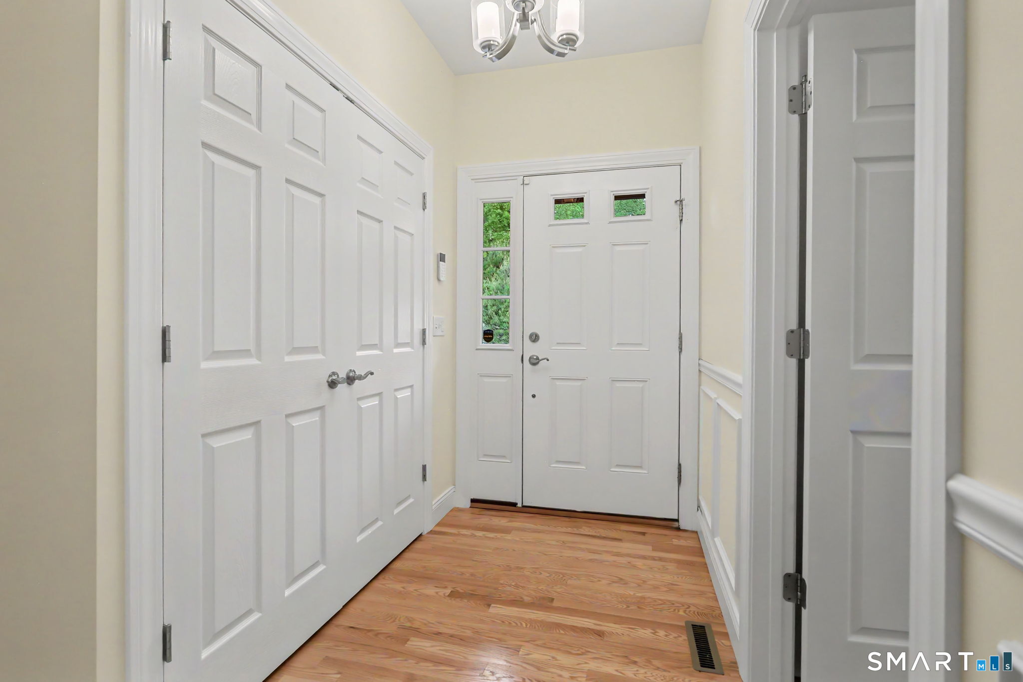 223 Meadow Brook Road, Unit 223 Oxford, CT 06478 - Photo 7 of 34 a view of a hallway with wooden floor
