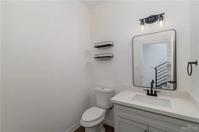 a bathroom with a toilet a sink and mirror
