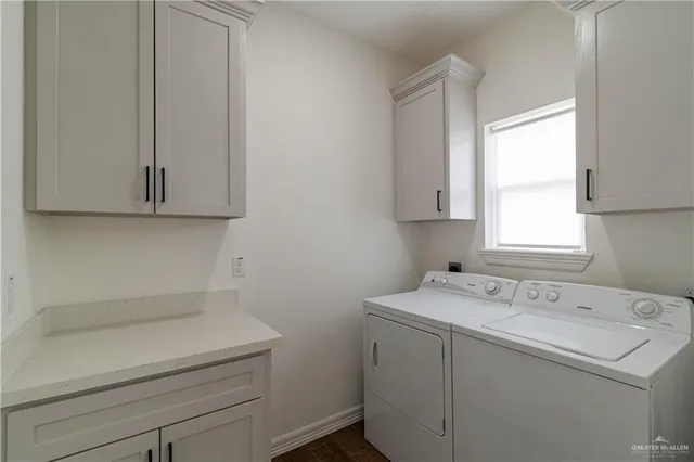 a utility room with a sink washer and dryer