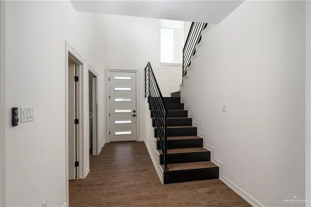 a view of entryway and hall with wooden floor
