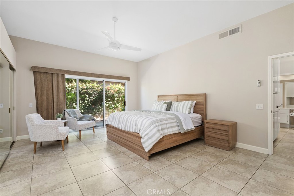 51 Pebble Beach Drive Rancho Mirage, CA 92270 - Photo 6 of 10 a bedroom with a bed and a couch