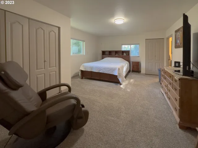 a bedroom with a bed and a flat tv screen