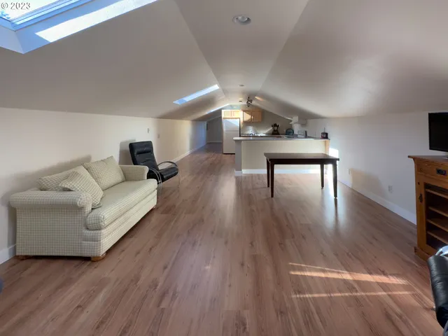 a kitchen with a sink cabinets and wooden floor