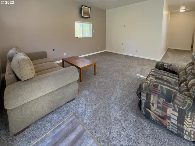 a kitchen with stainless steel appliances granite countertop a refrigerator a sink and a stove