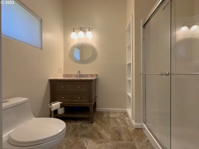 a bedroom with a bed and a wall painting