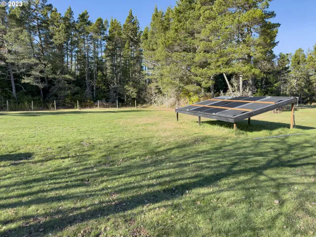 a view of a field with trees in the background