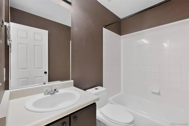 a bathroom with a sink mirror and vanity