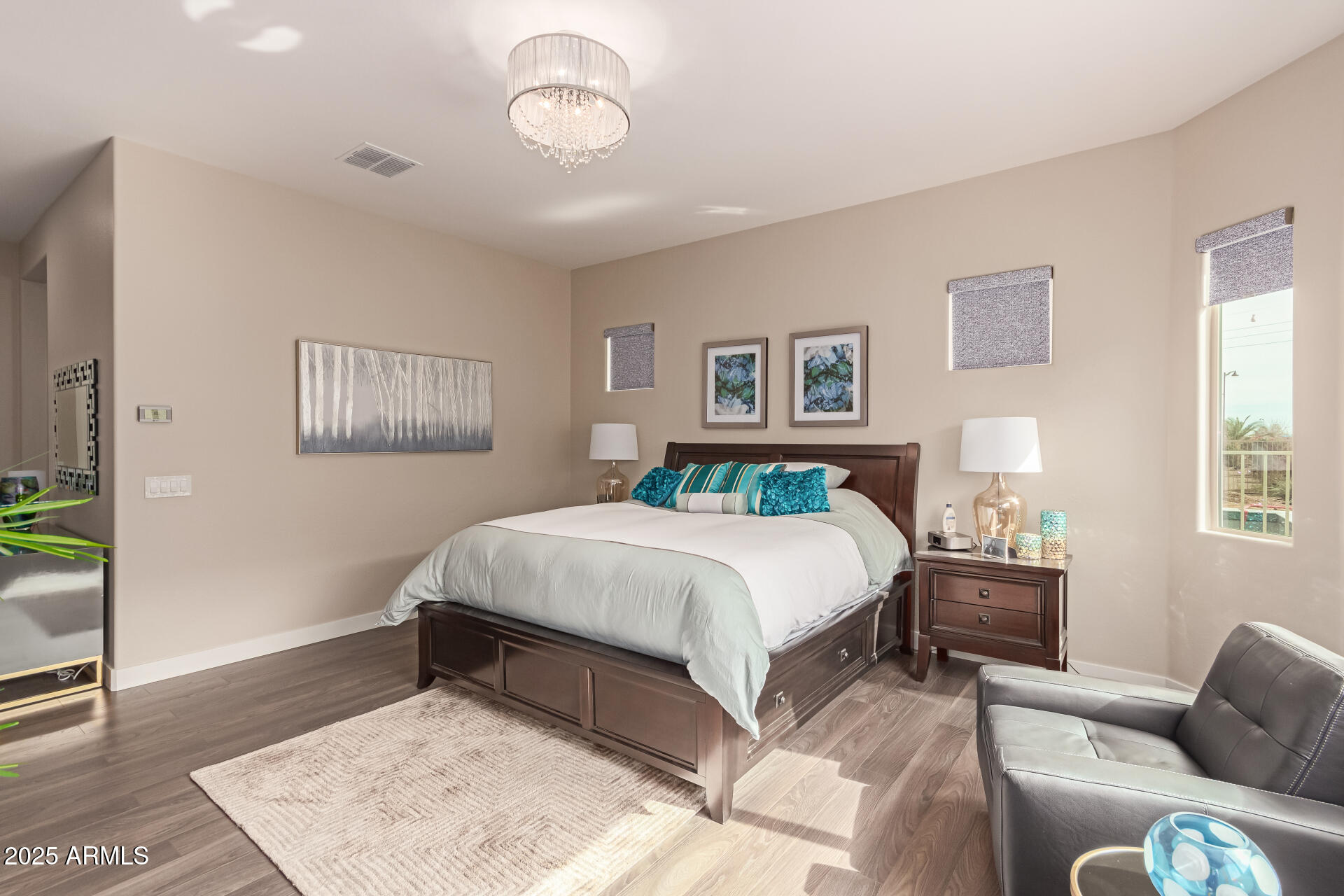 41737 West Cribbage Road Maricopa, AZ 85138 - Photo 19 of 35 a bedroom with a bed and wooden floor