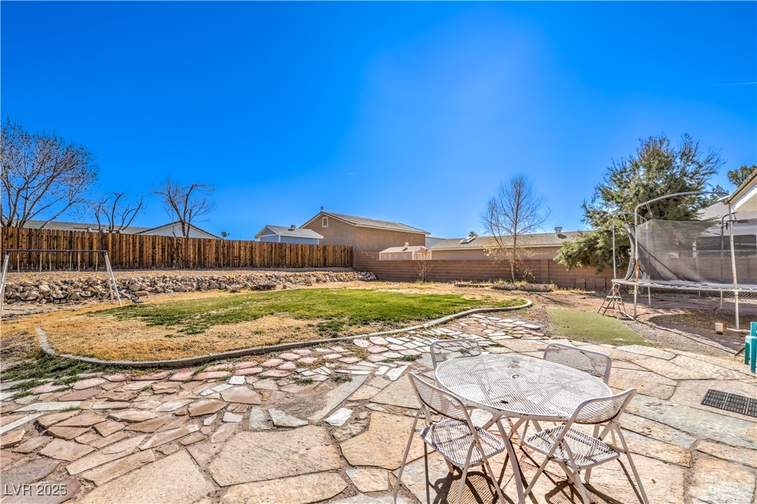 3192 North Taylor Street Logandale, NV 89021 - Photo 32 of 36 View of yard with a trampoline and a patio area